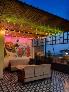 a patio with couches and lights on a building at Canvas and Cabana - Cabo in Sonīpat