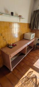 a kitchen with a counter with a microwave on it at Zorel House in Siena