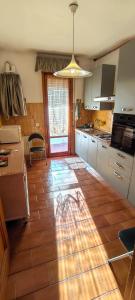 a kitchen with a tiled floor and a table at Zorel House in Siena
