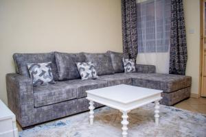 a living room with a couch and a coffee table at bluemoon in Watamu
