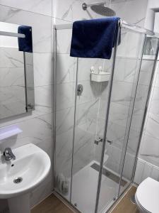 a bathroom with a shower and a sink at Casa La Peña in Luarca +7 photos