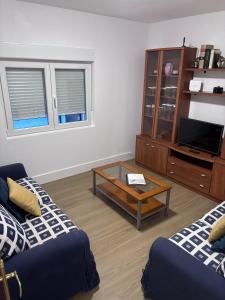 a living room with a couch and a coffee table at Casa La Peña in Luarca