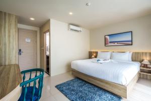 a bedroom with a white bed and a blue rug at Aqua Maya Phuket in Patong Beach +60 photos