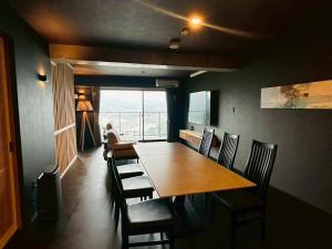 a dining room with a table and chairs and a window at Casa Luce Sasebo Hotel in Sasebo