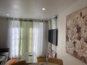 a living room with a table and a painting on the wall at Oshawa Suite Open Kitchen Living Space in Oshawa