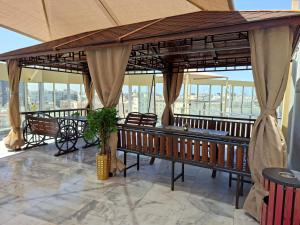 a pavilion with benches in a building with windows at Areen Almatar Serviced Apartments شقق ارين المطار للشقق المخدومة in Jeddah