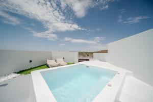 a swimming pool on the roof of a house at Caldera's Elements in Santorini