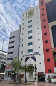 a tall white building with a star on it at Hotel Seri Warisan Melaka in Malacca