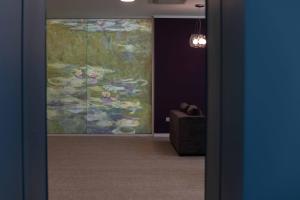 a room with a large painting on the wall at Impresamente Art Hotel in Sofia