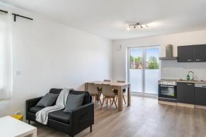 a living room with a couch and a table at Haus Seeluft - W4 in Butjadingen +11 photos