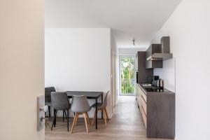 a kitchen and dining room with a table and chairs at Haus Seeluft - W5 in Butjadingen