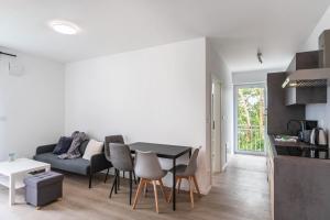 a living room with a table and a couch at Haus Seeluft - W5 in Butjadingen +9 photos