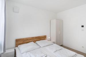 a bedroom with a bed with two white pillows at Haus Seeluft - W5 in Butjadingen