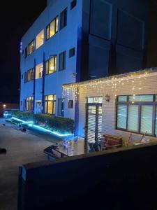 a building with lights on the side of it at night at 浮雲澗民宿 in Hu-hsia