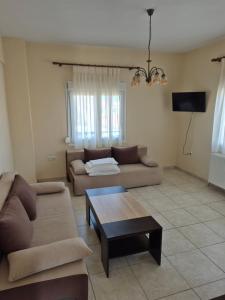 a living room with two couches and a coffee table at Villa Aggelos in Skala Sotiros