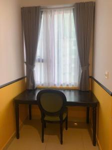 a desk with a chair in front of a window at NAYO Cam Ranh - Beachfront Residence in Cam Ranh International Airport +3 photos
