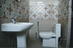 a bathroom with a sink and a toilet at Karma Bodhgaya in Bodh Gaya
