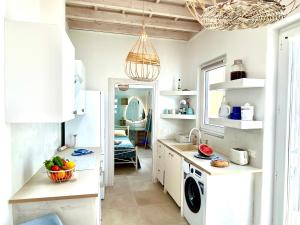 a kitchen with a sink and a washing machine at Cosy 21 in Ialysos