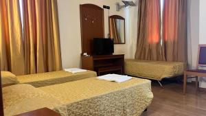 a hotel room with two beds and a mirror at Hotel Ristorante Wada in Malo