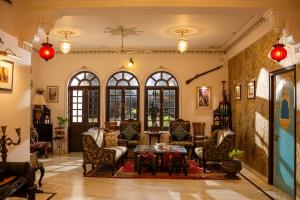 a living room with chairs and a table at Panna Vilas - A Lake Facing Boutique Hotel in Udaipur