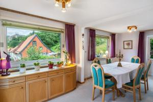 a dining room with a table and a large window at Ferienhaus Adelheid in Bad Grund