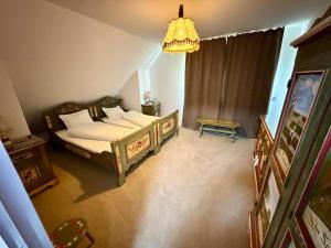 a bedroom with a bed and a chandelier at Casa cu Dor in Odăile