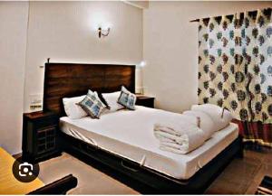 a bedroom with a large white bed in a room at Alwar stay in Alwar