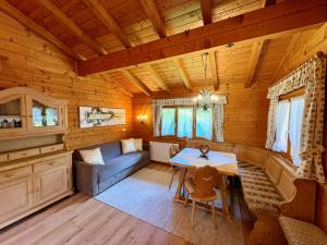a living room with a couch and a table in a cabin at Haus Martinus in Mayrhofen