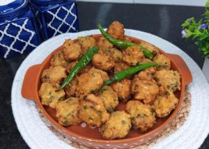 a plate of food with green peppers and cauliflower at Alwar stay in Alwar +12 photos