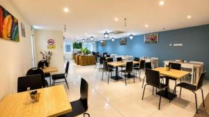 a dining room with wooden tables and chairs at Hotel Seri Warisan Melaka in Malacca