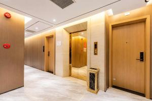 a row of elevators in a hallway of a building at Sunshine Grand Hotel in Móng Cái
