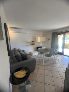 a living room with a couch and a table at Residence Orizzonti app n 21 in Golfo Aranci