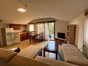 a living room with a couch and a table and a kitchen at Crescent Hasirci Hotel in Dalyan