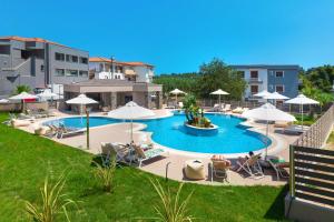 a large swimming pool with chairs and umbrellas at Anẽse Vacation Feelings in Paliouri +47 photos