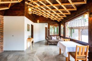 a living room with a table and a couch at Villa Alpina Borsec in Borsec