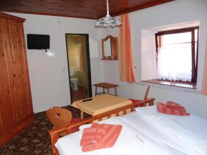 a bedroom with two beds and a table and a mirror at Schlummerburg in Weißkirchen in Steiermark