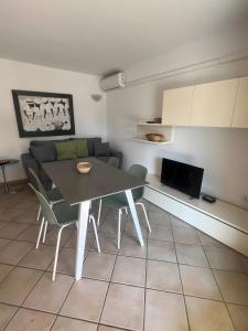 a living room with a table and a couch at Residence Orizzonti app n 21 in Golfo Aranci