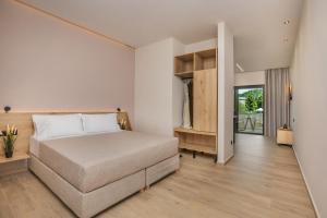 a bedroom with a large bed in a room at Anẽse Vacation Feelings in Paliouri