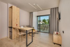 a kitchen with a table and chairs in a room at Anẽse Vacation Feelings in Paliouri