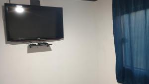 a flat screen tv hanging on a wall at Cantinho RMA in Bom Jesus dos Perdões