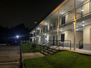 a building with a car parked in front of it at night at A Red Dot Inn in Milledgeville