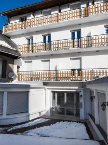 an external view of a building with snow on the ground at LE TOURISTIC Appartements T2 et T3 in Luz-Saint-Sauveur