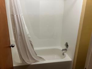 a bathroom with a shower curtain and a sink at A Red Dot Inn in Milledgeville +9 photos
