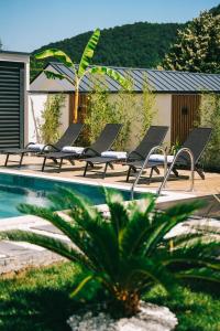 a group of lounge chairs next to a swimming pool at Rua Sapanca in Sapanca