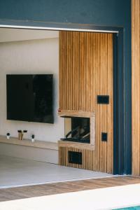 a living room with a tv and a wooden door at Rua Sapanca in Sapanca