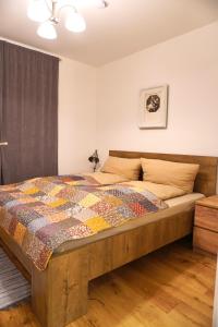a bedroom with a bed with a quilt on it at Moderne Sauerhof Apartments in Baden