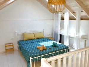 a bedroom with a bed with a teddy bear on it at Cosy 21 in Ialysos