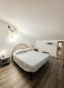 a bedroom with a large bed and a mirror at mansarda fronte mare in Potenza Picena