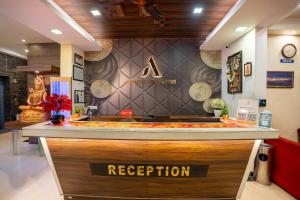 a reception counter in a restaurant with a sign on it at Ananya Comfortss in Hospet +71 photos