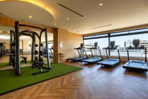 a gym with treadmills and cardio equipment in a building at Kushiro Prince Hotel in Kushiro